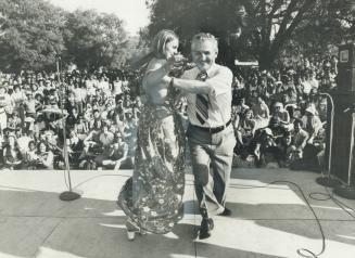 A former Miss Toronto, Pat Mazerick, 23, joins David Lewis, leader of the New Democratic Party, in a dance one one of the stages at yesterday's International Picnic
