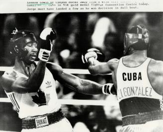 Lennox Lewis of Canada ducks away