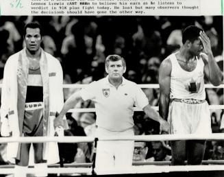 No way! Canadian super heavyweight Lennox Lewis, right, turns away and holds his head in disbelief after hearing Cuban Jorge Gonzalez, left, had won their gold medal bout on a 4-1 decision at the Pan American Games yesterday
