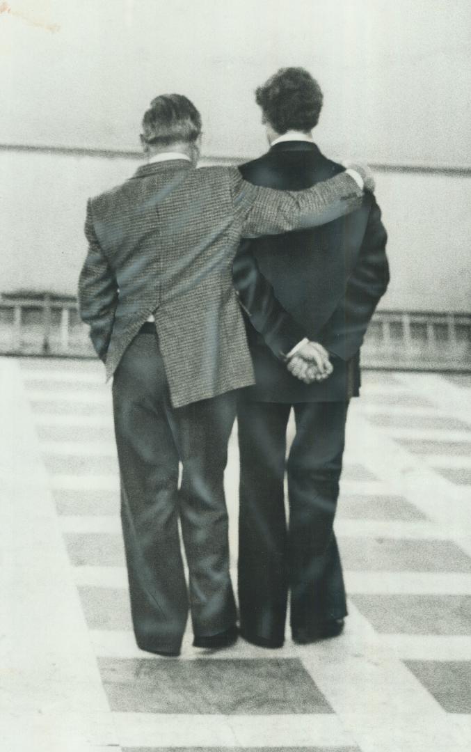 David Lewis, arm around the shoulder of his son, Stephen, on the busy night of Sept