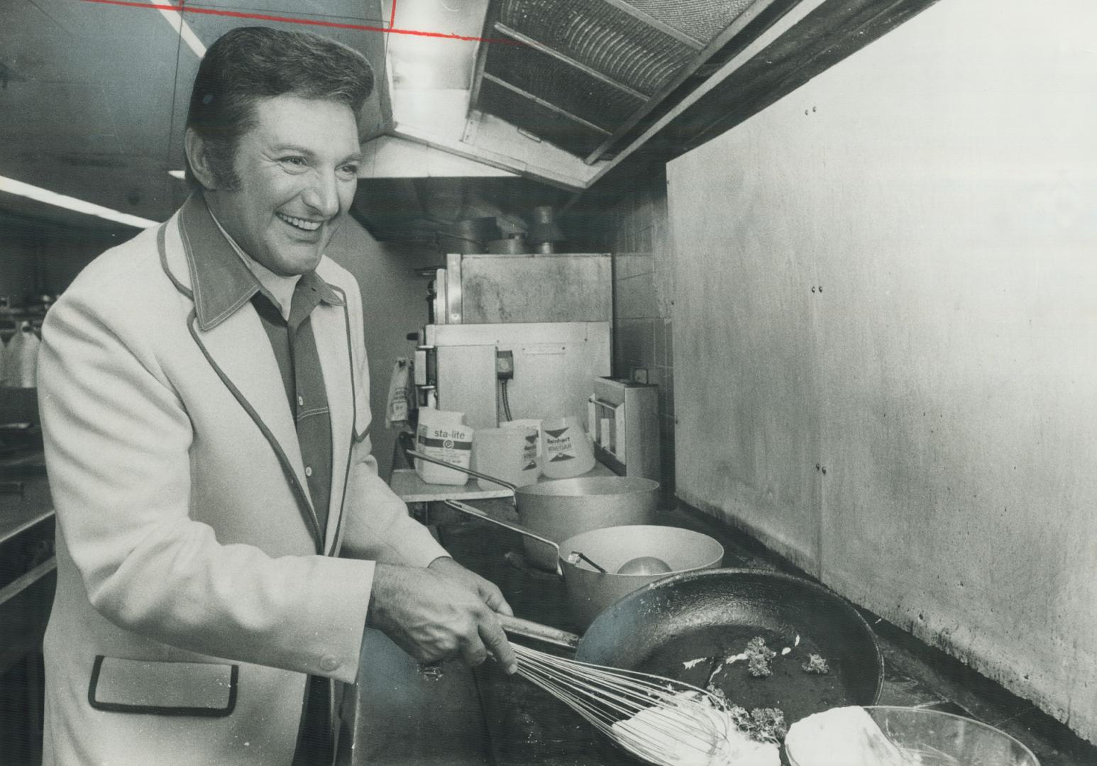 Liberace Demonstrates his cooking skill in the kitchen of O'Keefe Centre, where he has been performing this week