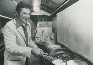 Liberace Demonstrates his cooking skill in the kitchen of O'Keefe Centre, where he has been performing this week