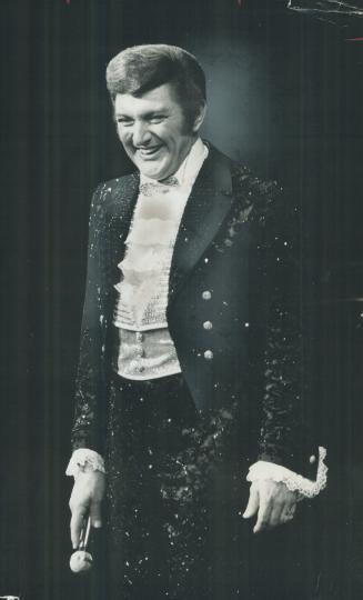 Liberace changes costumes more often than a motorist changes lanes, says critic William Littler