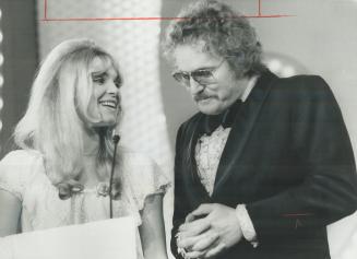 A Beardless Gordon Lightfoot and guitarist Liona Boyd last night presented award to Burton Cummings as best new male vocalist at the Juno Awards ceremonies, televised live from the Royal York Hote