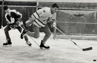 Backyard Shinny: Eric Lindros, 15, pulls away from brother Brett, 13, during backyard shinny game