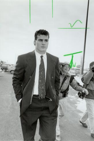 In The Spotlight: Hockey superstar Eric Lindros faced a barrage of cameras and fans when he appeared in an Oshawa court on assault charges.
