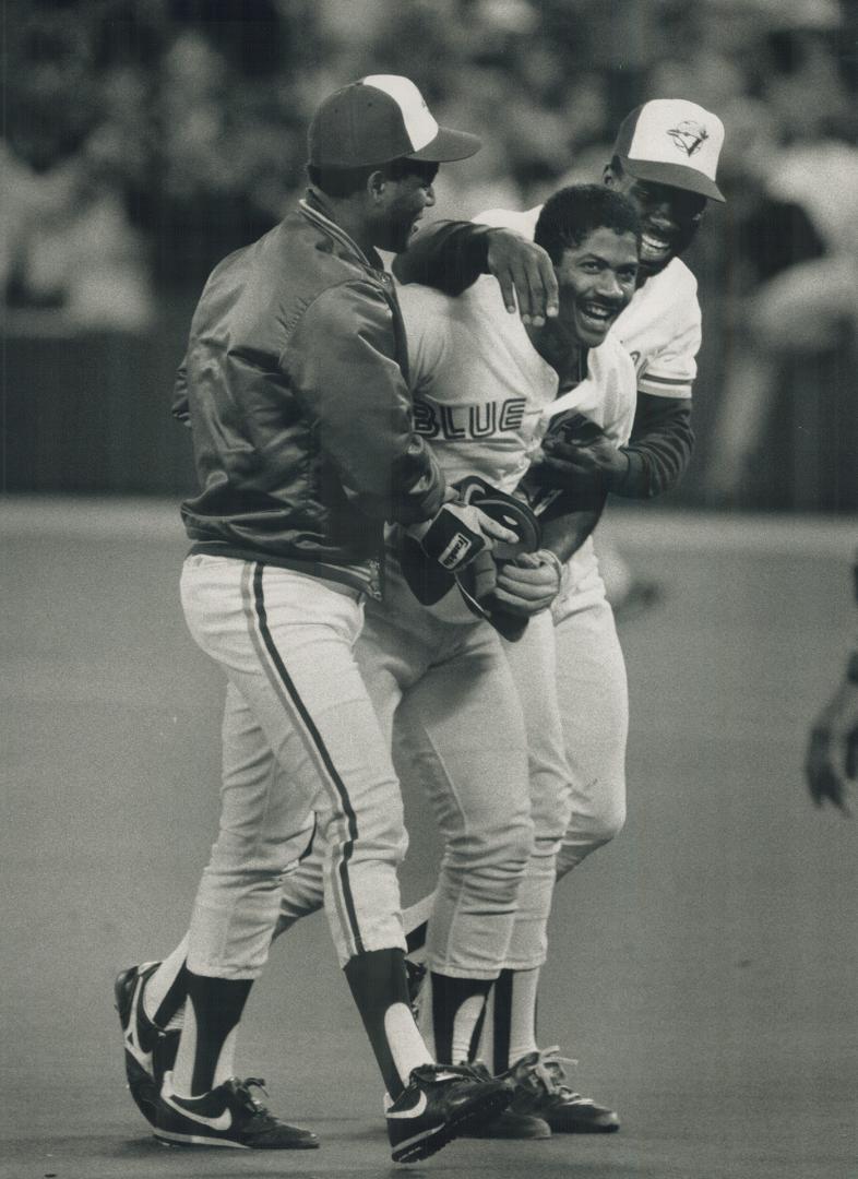 Extra-Inning hero: Nelson Liriano gets a hero's welcome from Glenallen Hill, left, and Mookie Wilson after his double in the 13th gave the Jays and improbable 6-5 victory and kept the Orioles two lengths back in AL East race