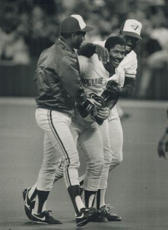 Extra-Inning hero: Nelson Liriano gets a hero's welcome from Glenallen Hill, left, and Mookie Wilson after his double in the 13th gave the Jays and improbable 6-5 victory and kept the Orioles two lengths back in AL East race