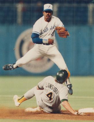 That helps: With two runners on and none out for the A's in the sixth inning last night, the Jays got out of trouble when Mark McGwire grounded to Tony Fernandez, who tossed to Nelson Liriano, who jumped over Carney Lansford and threw to first for a double play