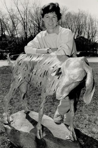 Gallery pet: Latcham Gallery director Vanessa Perry poses with Bill Lishman's sculpture of a goat, part of the gallery's permanent collection.