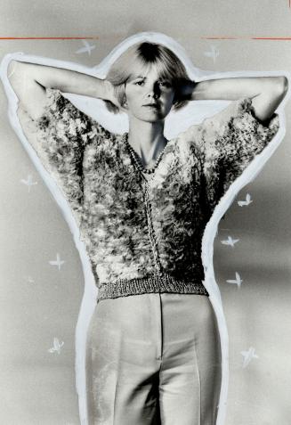 The inventor of a new technique for knitting fur, textile artist Paula Lishman, models one of her creations: A short-sleeved pull-over in sheared fawn rabbit with natural doeskin crocheted down the front
