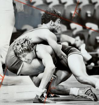 A bad day for Canada's wrestlers. Parents see Clive Llewellyn (above) lose.
