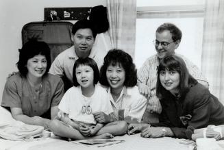 Team of fighters: Elizabeth Lue, 6, smiles as family and friends visit in hospital. From left, mother Phillipa and father Gary, aunt Julie Ho-Tseung, and campaign organizers Dr. Marshall Deltoff and Helen Cox.