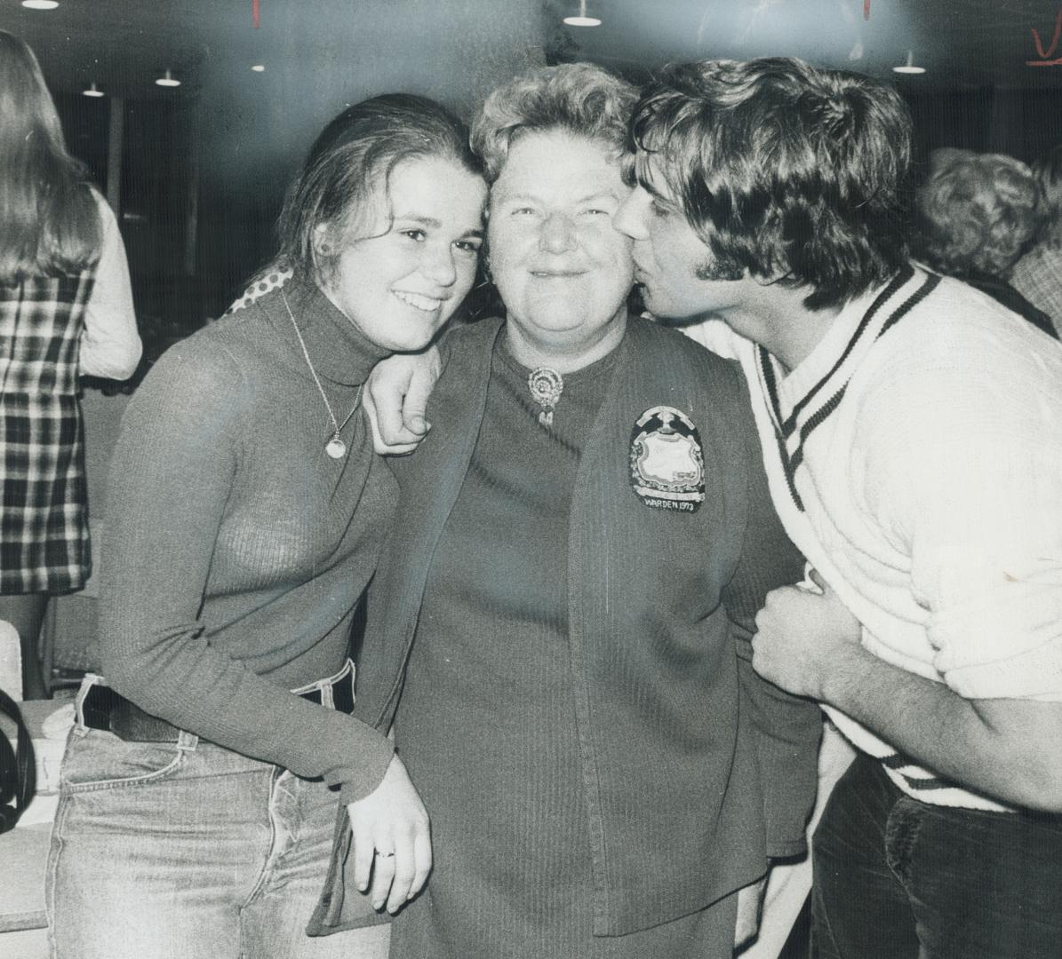 Anne MacArthur, the 63-year-old former teacher of history who was elected mayor of Milton last night, is congratulated by two students who worked on her campaign