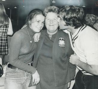 Anne MacArthur, the 63-year-old former teacher of history who was elected mayor of Milton last night, is congratulated by two students who worked on her campaign