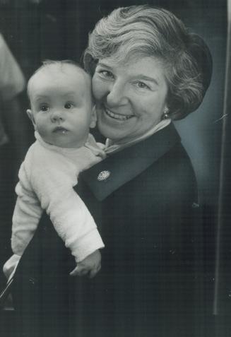 Getting oriented politically, in what her family would consider a proper setting, 4-month-old Amea Wilbur, youngest person attending the New Democratic Party leadership convention, is held by Mrs