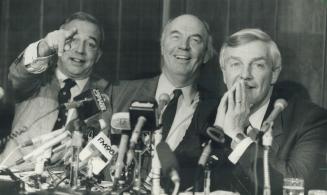 Free trade drive: Former Ontario treasurer Darcy McKeough gestures to a reporter during a Toronto news conference with exfederal cabinet minister Donald Macdonald and former Alberta premier Peter Lougheed