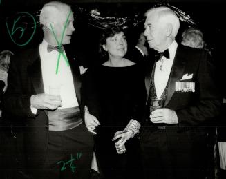 Above, savvy politician Barbara McDougall in basic black velvet chats with a bemedalled Senator Finlay MacDonald.