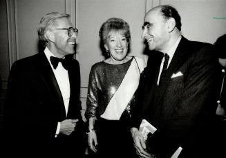 All in a night's work: Federal Communications Minister Flora MacDonald chats with broadcaster/author Knowlton Nash (lef) and author Peter C
