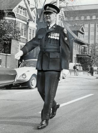 Leading his men in the annual church parade of the Metropolitan Toronto Police War Veterans Association, Police Chief James Mackey heads yesterday's march on Bloor St
