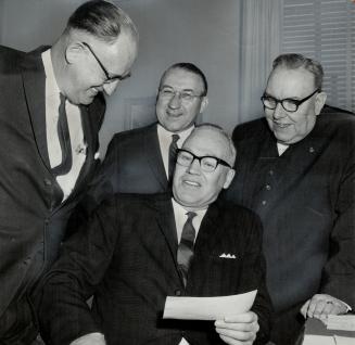 James Bartlett (left) presents cheque to police chief Mackey. Looking on are Shriners Chalres E. Wells and A. J. B. Gray (right)