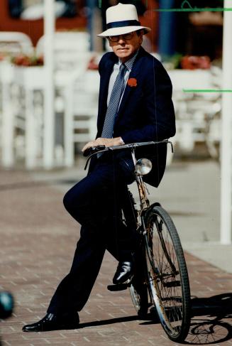 Bespoke: Above, veteran cycling commuter Roy MacLaren, chairman of CB Media, has a tailor in London, England make him suits with reinforced knees, a hidden pocket to carry business papers, and an anchor thread for the flower he sometimes wears in his lapel