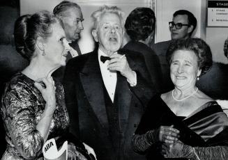 Sir Ernest McMillan and his wife chat with Mrs. Eric G. Thomson during opera interval