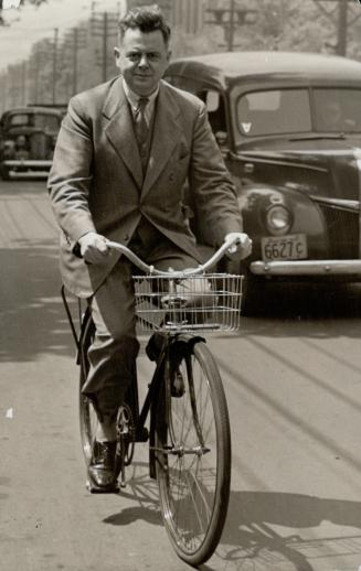 Sir Ernest MacMillan, eminent Canadian musician, keeps both gasoline consumption and waistline at a minimum by riding his bicycle to work