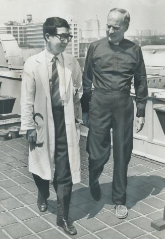 I've Got energy again, heart transplant recipient Rev. Edward Madigan says as he walks on the roof garden of St. Michael's Hospital with Dr. James Yao. Father Madigan expects he'll be released from hospital soon.