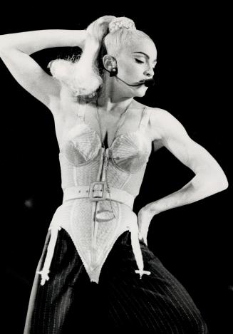 New Material: With no sign of the throat virus that cancelled her Chicago concert, superstar Madonna puts on a raunchy spectacle of dance and music for 27,000 fans at SkyDome last night, including songs from her new album I'm Breathless from the movie Dick Tracy