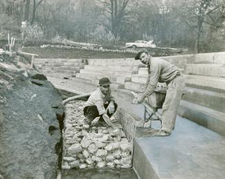 Workmen lay stones in $280,000 Humber flood control