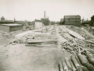 Image shows a construction area with a lot of construction materials around.