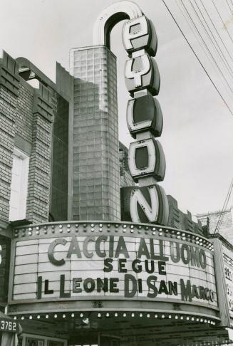 Marquee signage; Vertical section spells PYLON. Billboard section below reads, Caccia Alluoma S ...