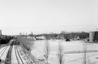 Looking north from Dundas Street West and the Canadian Pacific Railway tracks showing West Toronto Secondary School and MacGregor Playground on right, Toronto, Ont.