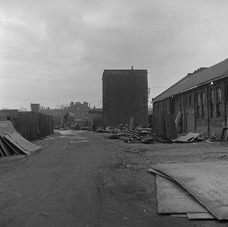 Lane, west of Abell Street, looking south across CN - CP railway tracks. Andrew Mercer Reformatory for Women is visible in the background. Toronto, Ont.