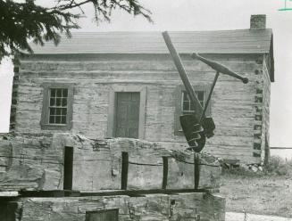 Broad axe, auger, and 1830 cabin in Markham, Ont.