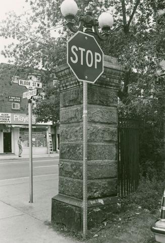 Gate post at Palmerston Boulevard, southeast corner of Bloor Street West, looking northeast to north side of Bloor Street, Toronto, Ontario.