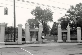 Trinity College (1852-1925) gates, Queen Street West, north side, at Trinity Drive, between Gore Vale Avenue and Crawford Street, Toronto, Ontario.