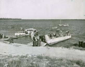 View of landing at Moosonee showing landing barge leaving with pilgrimage returning to Moose Factory