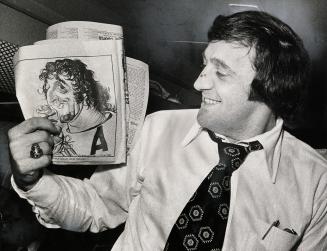 Esposito and friend. Phil Esposito, on plane home, takes delight in cartoon by The Star's Duncan Macpherson, who in a laudatory comment nominated him (...)