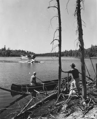 OCC Beaver picking up Forest Protection men in [Dillon] Lake. Algonquin Provincial Park, Ontario