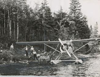 Norseman plane unloading firefighting supplies at Round Island Lake, Algonquin Provincial Park, Ontario