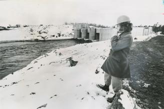 Hydro employee B.D. Potts looks over newly built spillway, Arnprior, Ontario