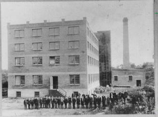 Employees of Aurora Collis Tannery on Tyler Street posed outside the building in 1913, Aurora, Ontario