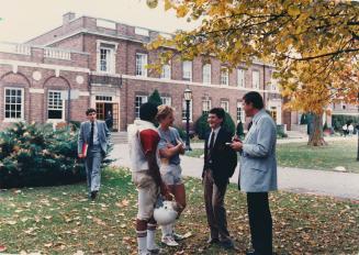 Aubrey Foy (right), housemaster of Flavelle House, chats with students (from far left) Ivan Lavrence, Sandeep Sharma, Robert Duve and Jason Campbell outside Dunlap Hall at St. Andrew's College in Aurora, Ontario