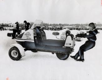 Woman pulling a snowmobile, Barrie Winter Carnival, Barrie, Ontario