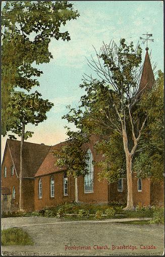 Colorized photograph a brick church in a small town.
