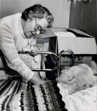 Mary Love, director of the Armstrong Nursing Home, is packing patients' belongings in preparation to move. Bolton, Ontario