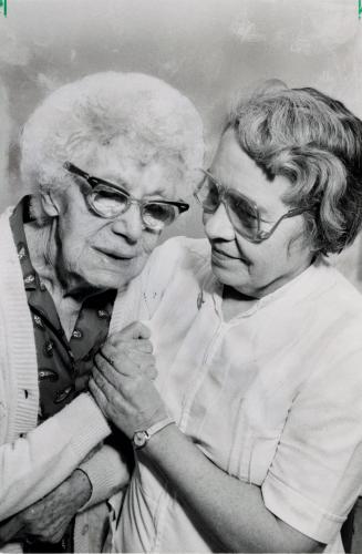 Cora Bunce, 84, is comforted by Armstrong Nursing Home nursing director Mary Love as residents prepare for relocation. Bolton, Ontario
