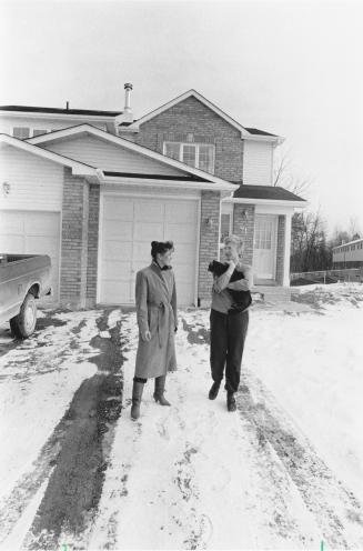 Sales agent Pat Armstrong with Ruth Aubert outside her home. Bowmanville, Ontario